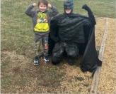 A child and Batman-costumed visitor outdoors